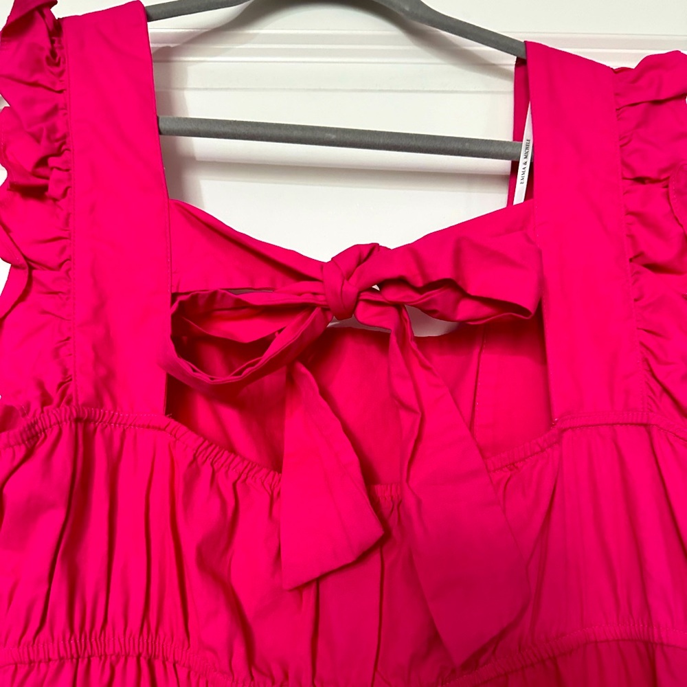 A beautiful berry colored long dress. With cute ruffles and tie back.